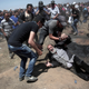 An elderly Palestinian man falls on the ground after being shot by Israeli troops during a deadly protest at the Gaza Strip’s border with Israel, east of Khan Younis, Gaza Strip, on May 14, 2018.